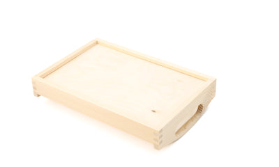 A rectangular wooden tray with cut out handles on a white background turned upside down