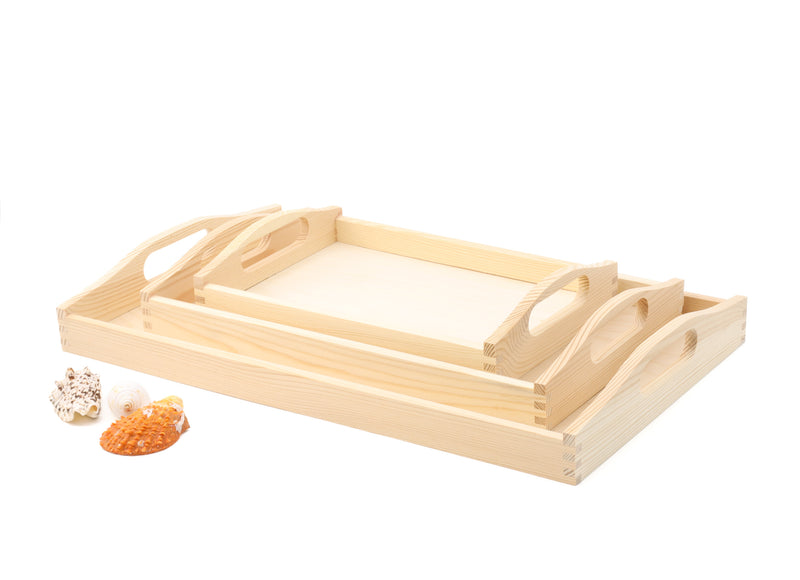 A set of 3 unfinished wooden trays with cut out handles on a white background. The trays come in different sizes and shapes: small (30cmx20cmx5cm), medium (39.5cmx24cmx6.3cm), and large (50cmx40cmx6.3cm). The trays have a natural wood color and texture. They can be used for serving, organizing, or decorating.